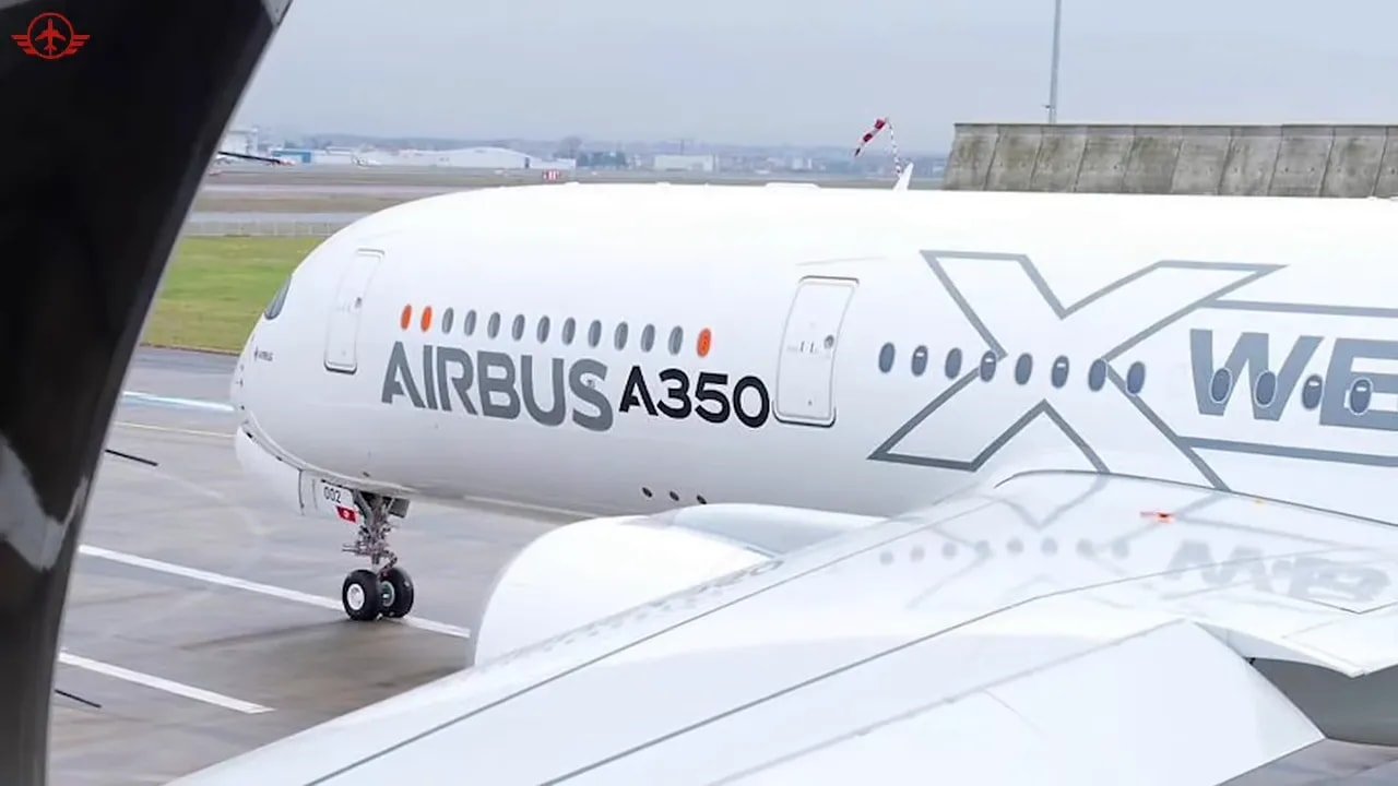 Airbus A350 XWB seen through another aircraft window with wing in foreground