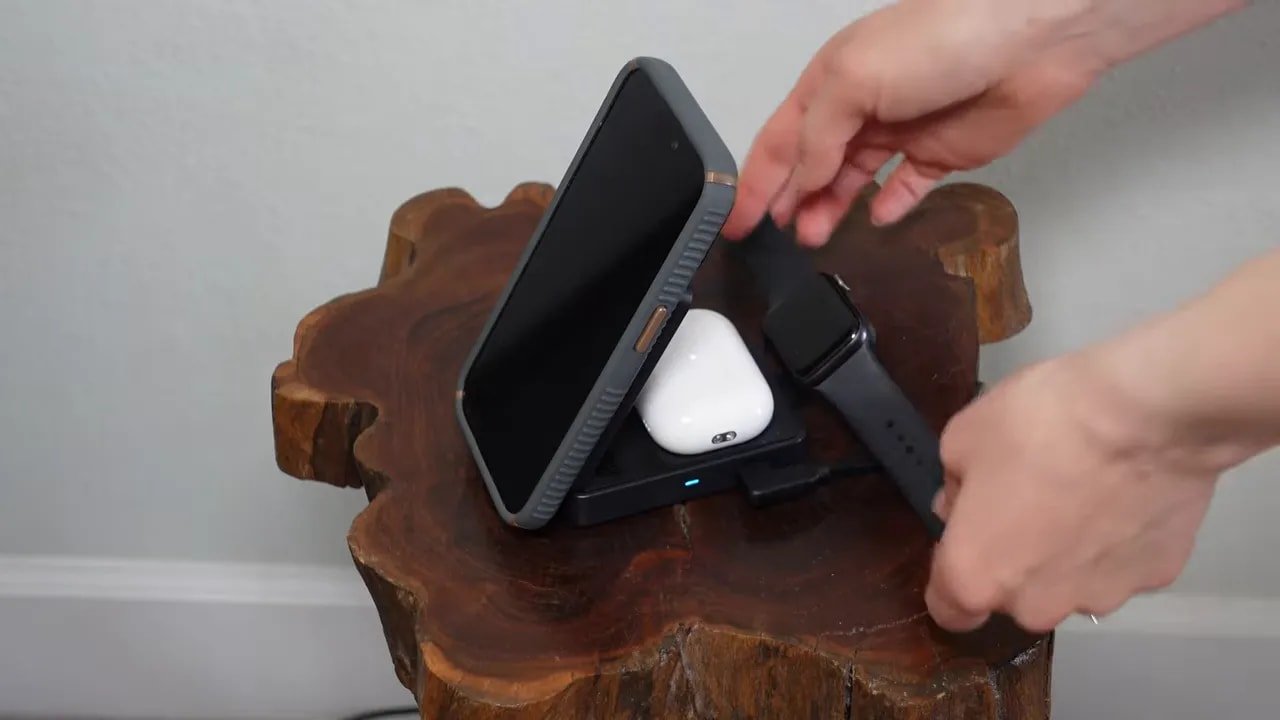 Foldable black charging station holding a phone with space for AirPods case and Apple Watch charger
