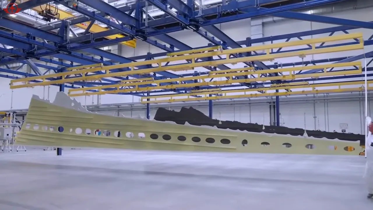 wide view of a Boeing assembly line with multiple green fuselages in production